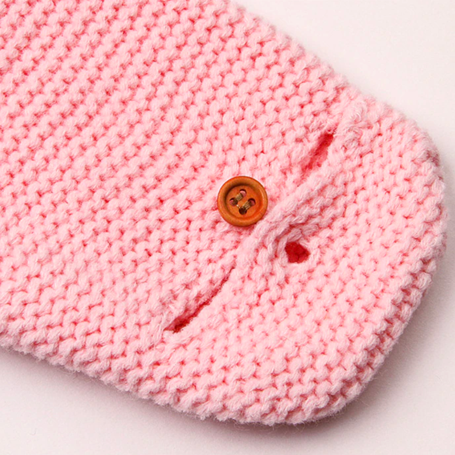 Close-up of the mitten sleeve on a pink knitted bunny rabbit sleep sacks sleeping bags for newborn babies and reborn dolls.