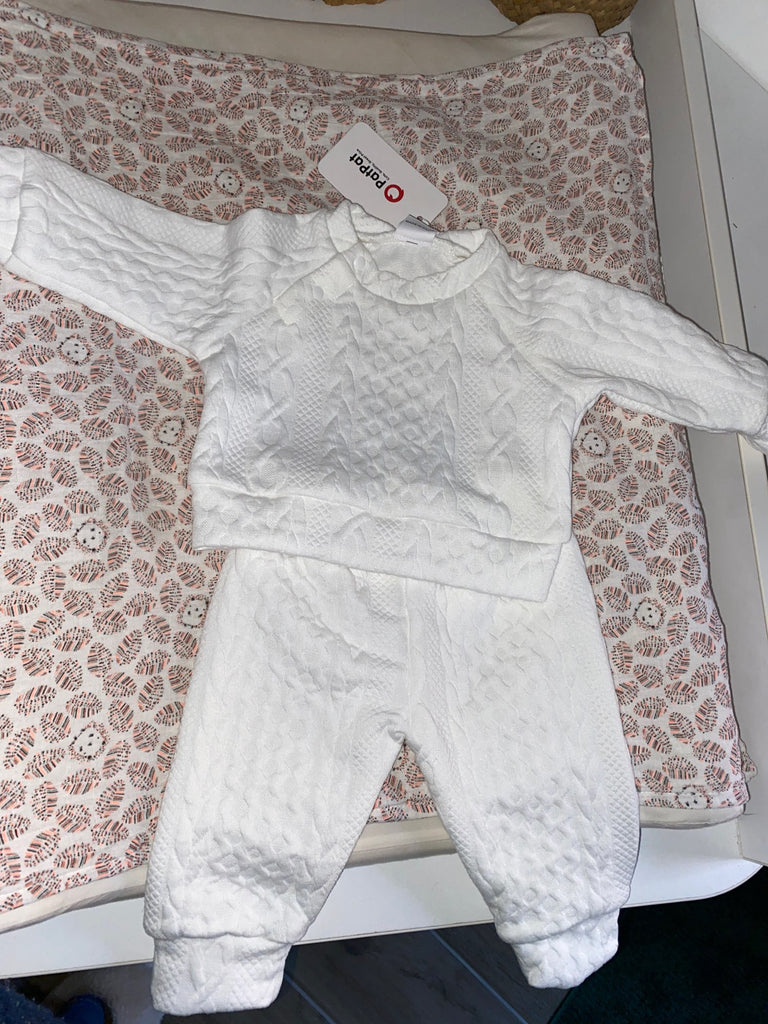Real life photo of white cable knit knitted jogging suit from PatPat with pullover. two piece outfit with matching pants for reborn dolls or cuddle babies or newborn babies. Hand knit newborn outfit.