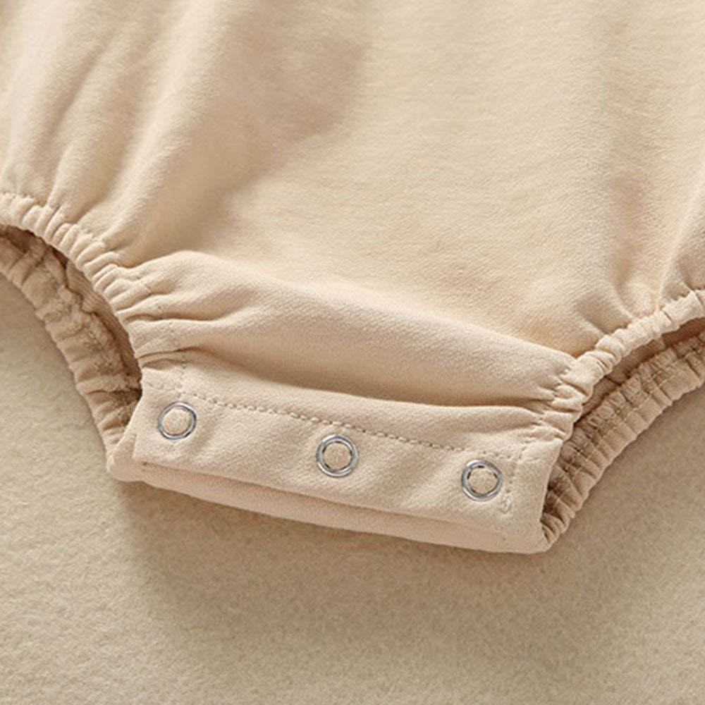 Close-up of snap closures on the crotch of the beige light brown tan colored teddy bear overall bubble romper onesie for reborn baby dolls. Great clothing for twins!
