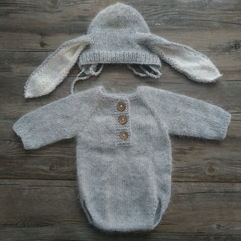 Light grey knitted bunny rabbit newborn photography hat and long-sleeve onesie bodysuit for reborn baby dolls.