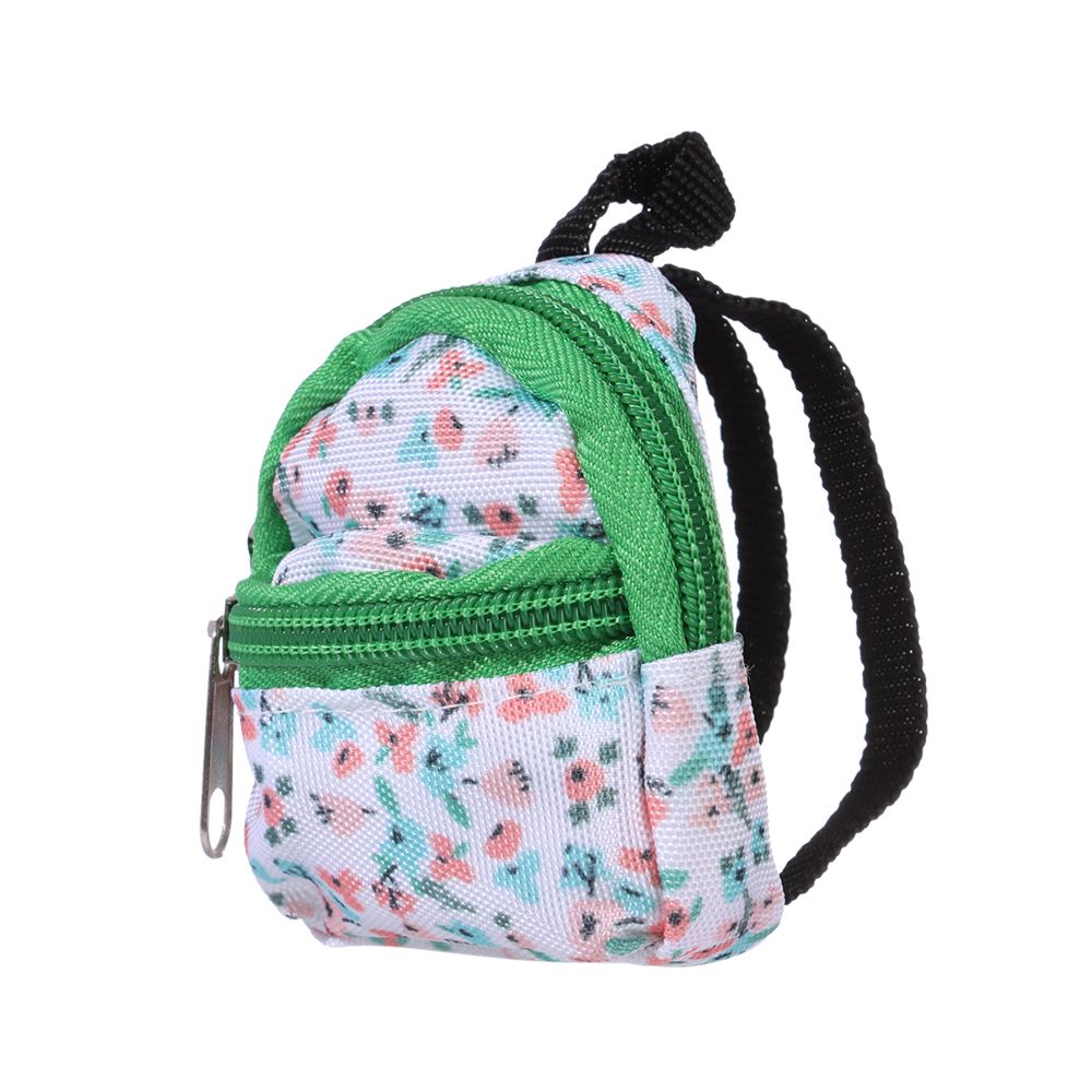 Side view of the green and floral miniature backpack with front zipper and main zipper for mini reborn silicone piglets, pandas, hamsters, Blythe dolls, barbies, BJD dolls and other small dolls.
