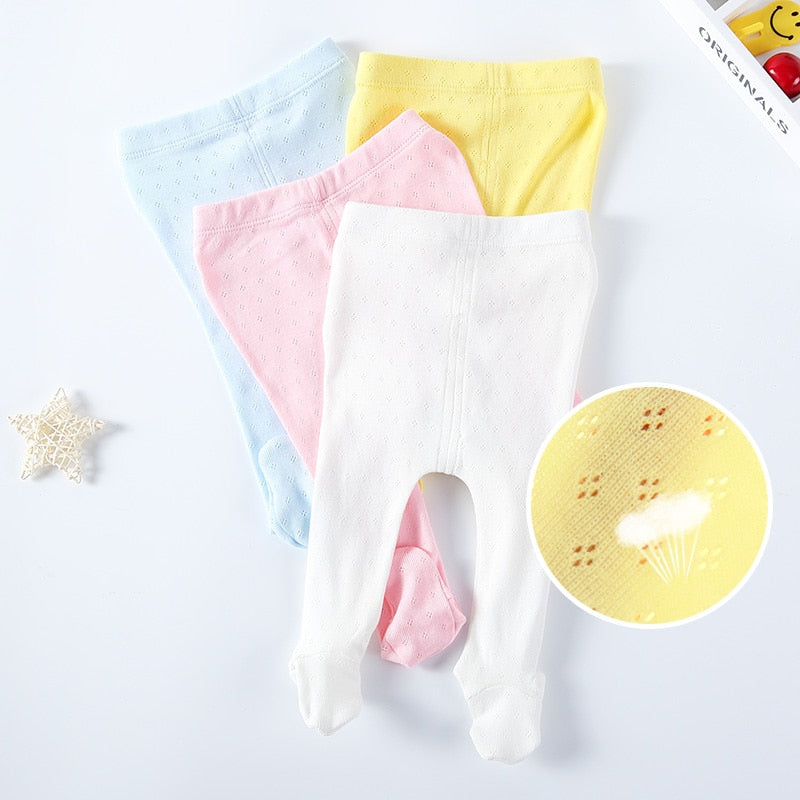 Newborn baby girl eyelet leotards in white, pink, baby blue and yellow for reborn dolls.