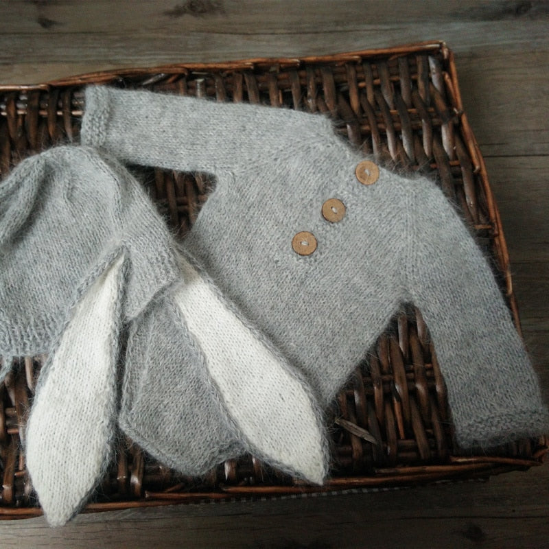 Light grey knitted bunny rabbit newborn photography hat and long-sleeve onesie bodysuit for reborn baby dolls.
