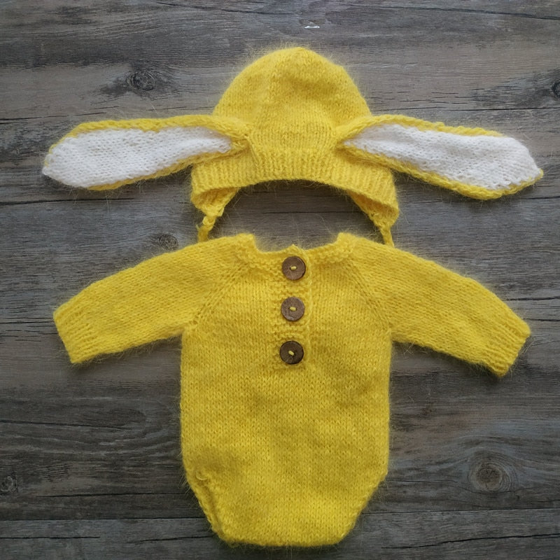 Bright yellow knitted bunny rabbit newborn photography hat and long-sleeve onesie bodysuit for reborn baby dolls.