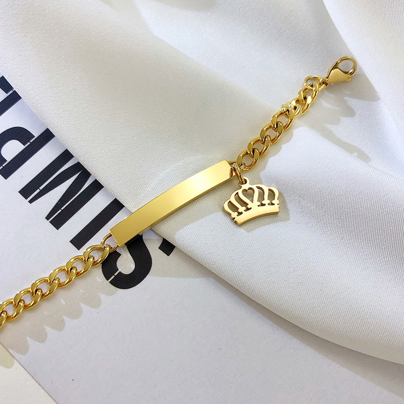 Baby bracelet in yellow gold plated stainless steel for reborn dolls with a crown charm.