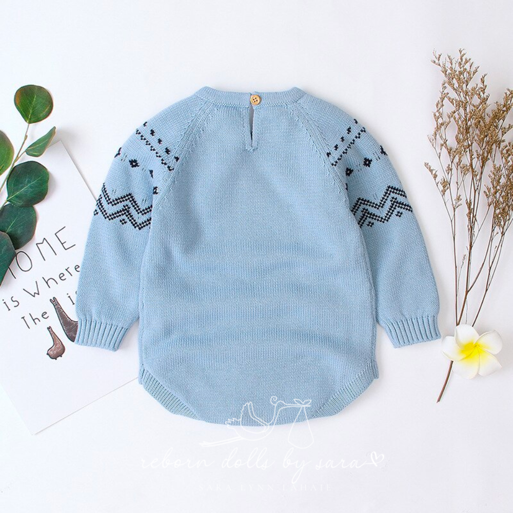 Back of a blue knitted long-sleeve sweater onesie romper for reborn baby dolls.