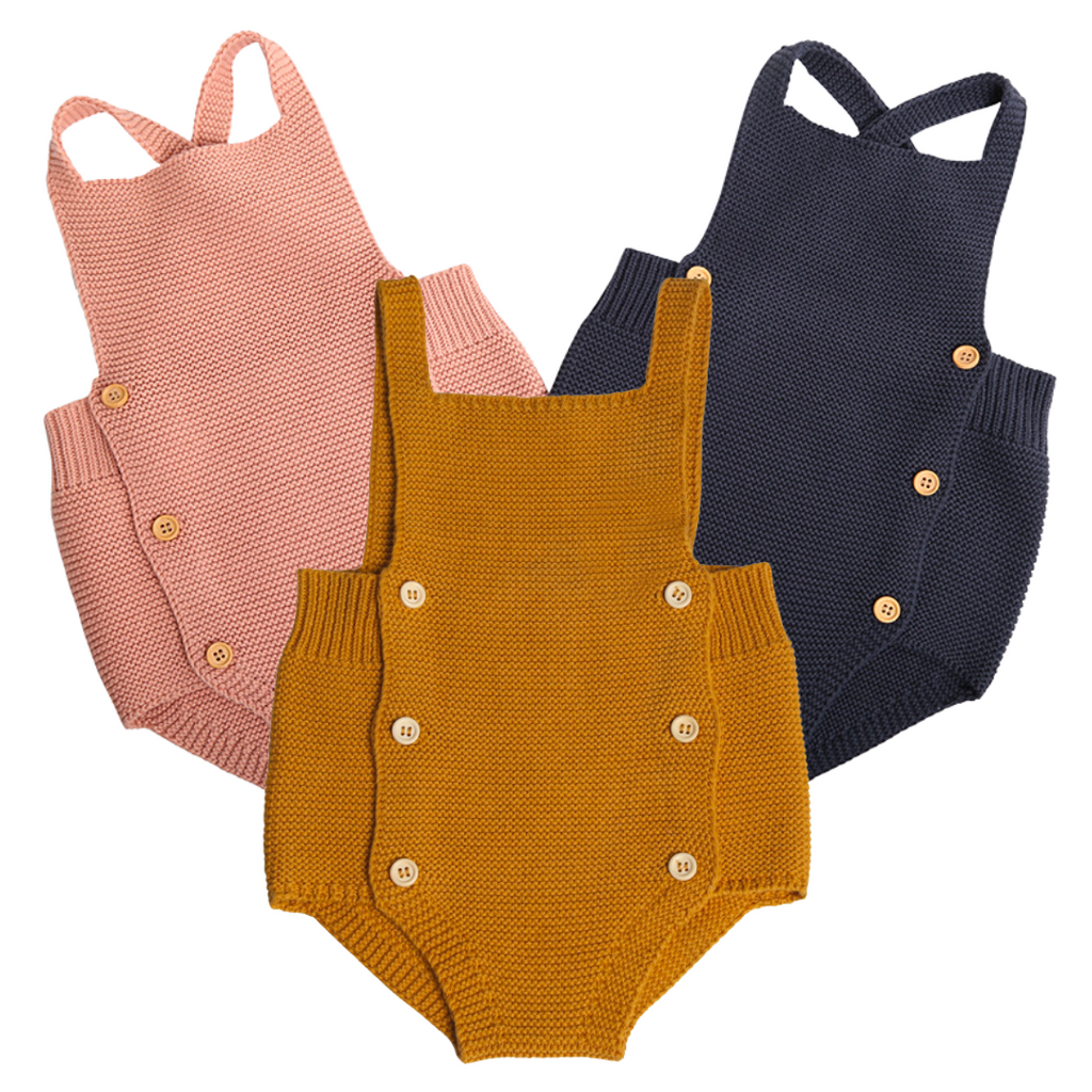 Knitted overall romper onesies in mustard yellow, navy blue, and pink for newborn baby girls, baby boys, and reborn dolls. 