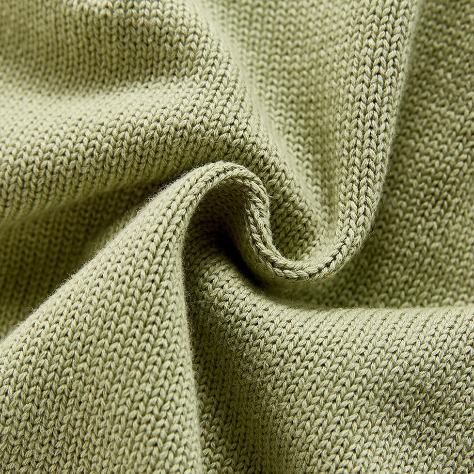 Close up of Olive green color knitted overall romper with adjustable straps for baby boys, baby girls, reborn dolls, reborns and cuddle babies.