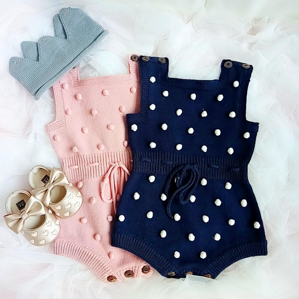 Baby pink and navy blue sleeveless knitted bubble rompers with pompoms for baby girls and reborn dolls.  