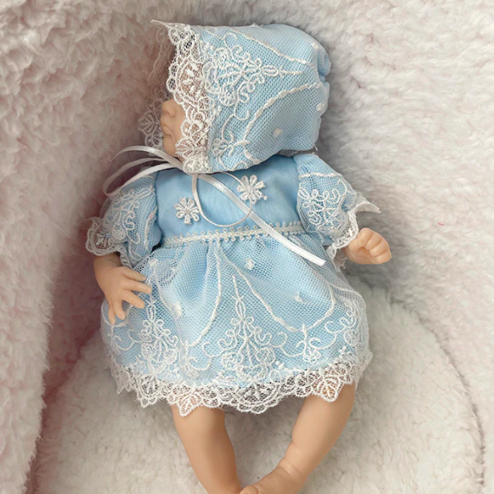 Miniature micro mini reborn doll wearing a blue vintage lace dress with handmade bonnet.