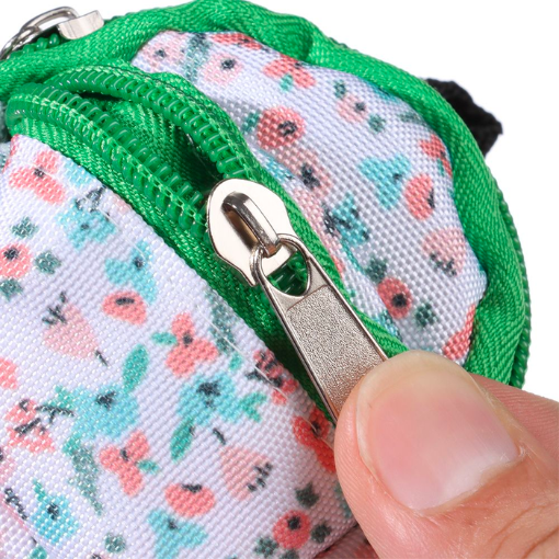 Close-up of the zipper on the green and floral miniature backpack with front zipper and main zipper for mini reborn silicone piglets, pandas, hamsters, Blythe dolls, barbies, BJD dolls and other small dolls.