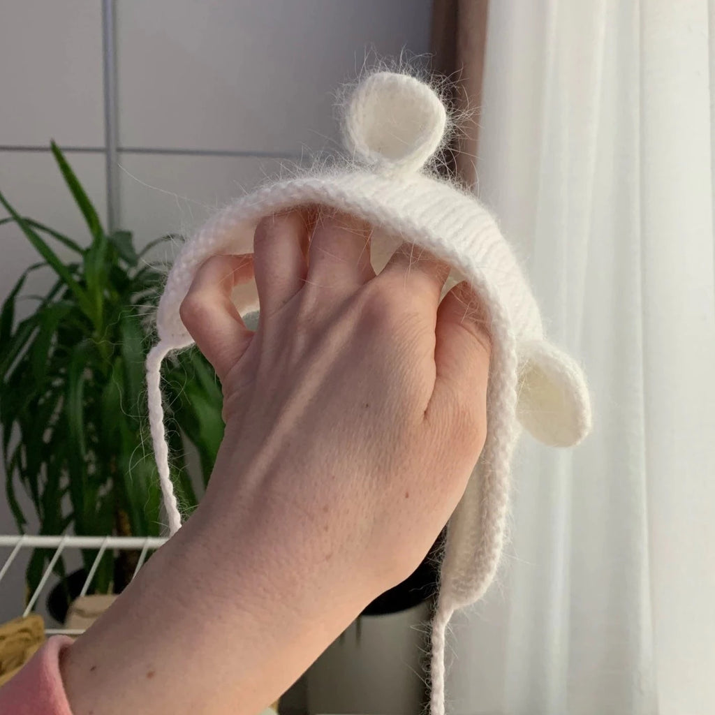 Lady holding the ivory white mohair hat in her hand to show size. 