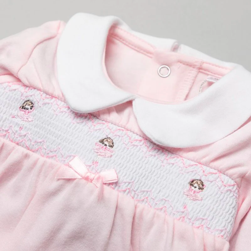 Close up of Pink and white Spanish Vintage Rock a Bye Baby smocked cotton footed romper pyjama sleep suit with ballerinas for newborn baby girl babies and reborn dolls.