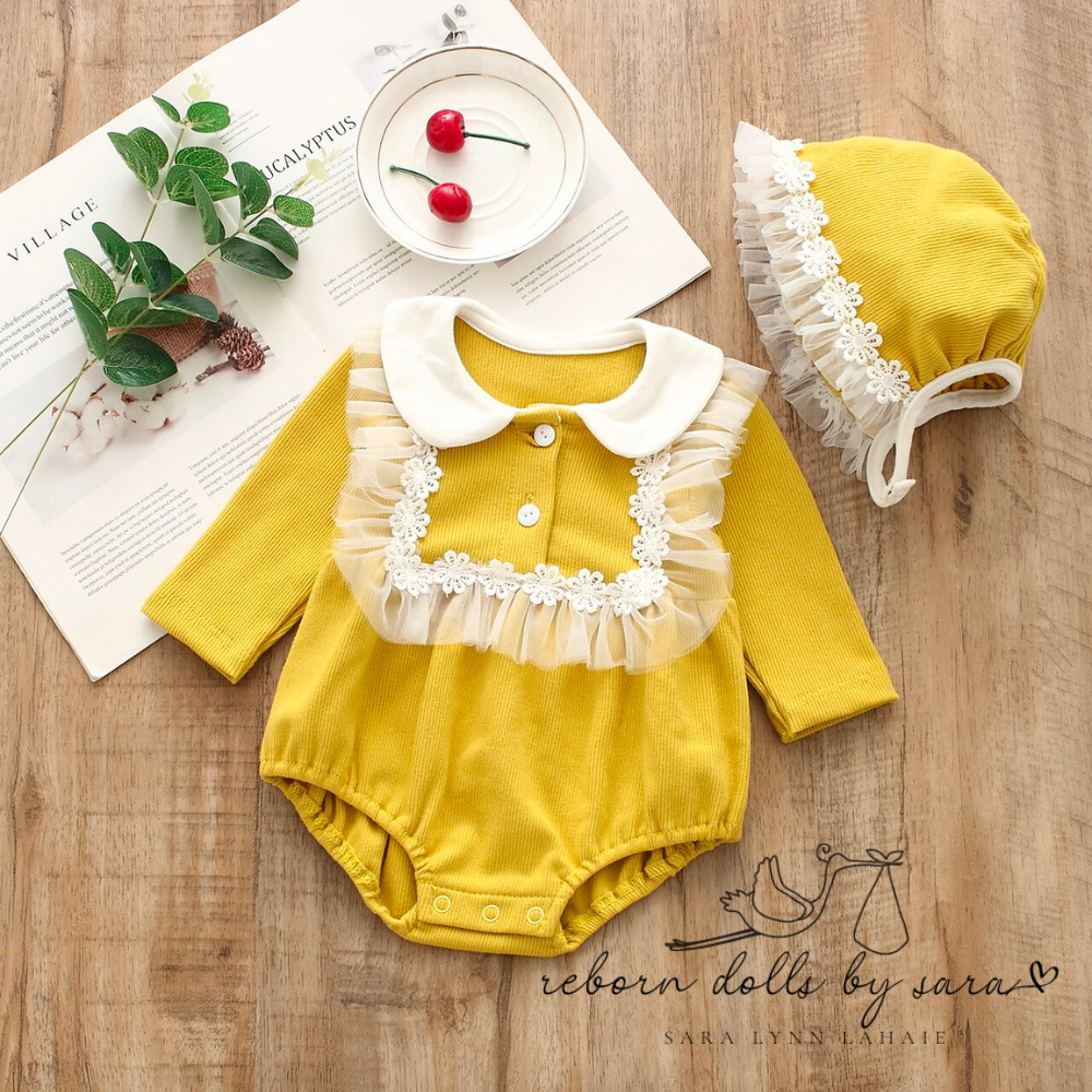Mustard yellow long sleeve peter pan collar cotton bubble romper with floral lace bib and matching bonnet with lace for baby girls reborns reborn dolls cuddle babies.