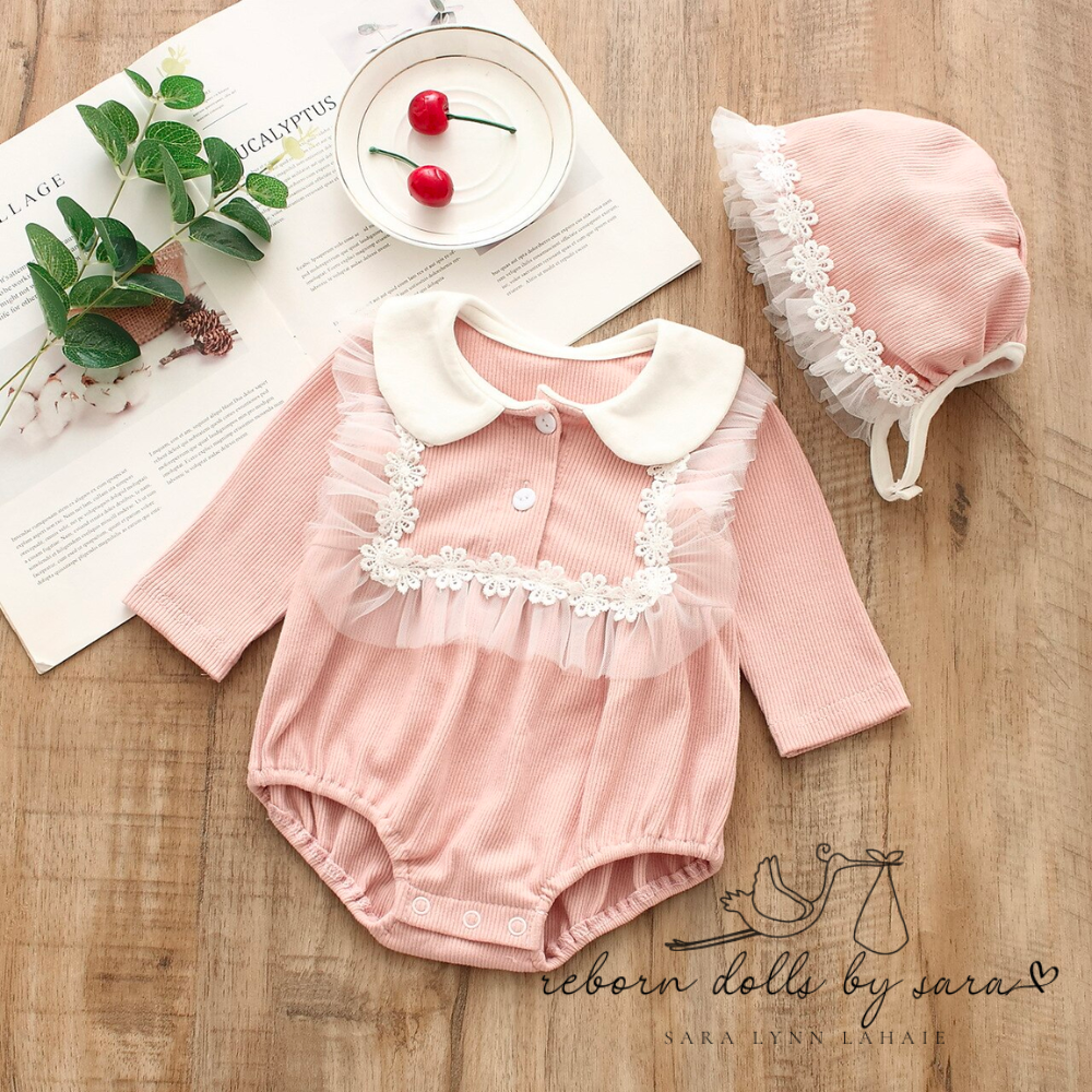 Pink long sleeve peter pan collar cotton bubble romper with floral lace bib and matching bonnet with lace for baby girls reborns reborn dolls cuddle babies.