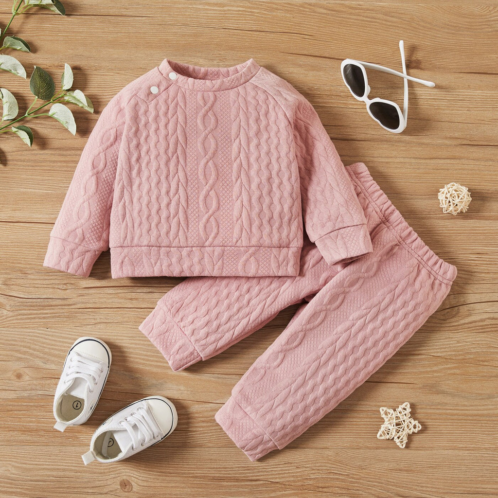 Pink cable knitted pullover two piece outfit with matching pants for reborn dolls or cuddle babies or newborn babies. Hand knit gender neutral newborn baby outfit.