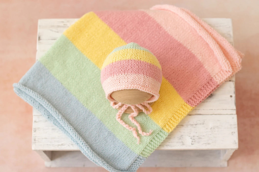 The bundlejoy pastel rainbow coloured hand knitted and crocheted newborn baby photography wrap and bonnet for babies and reborn dolls.