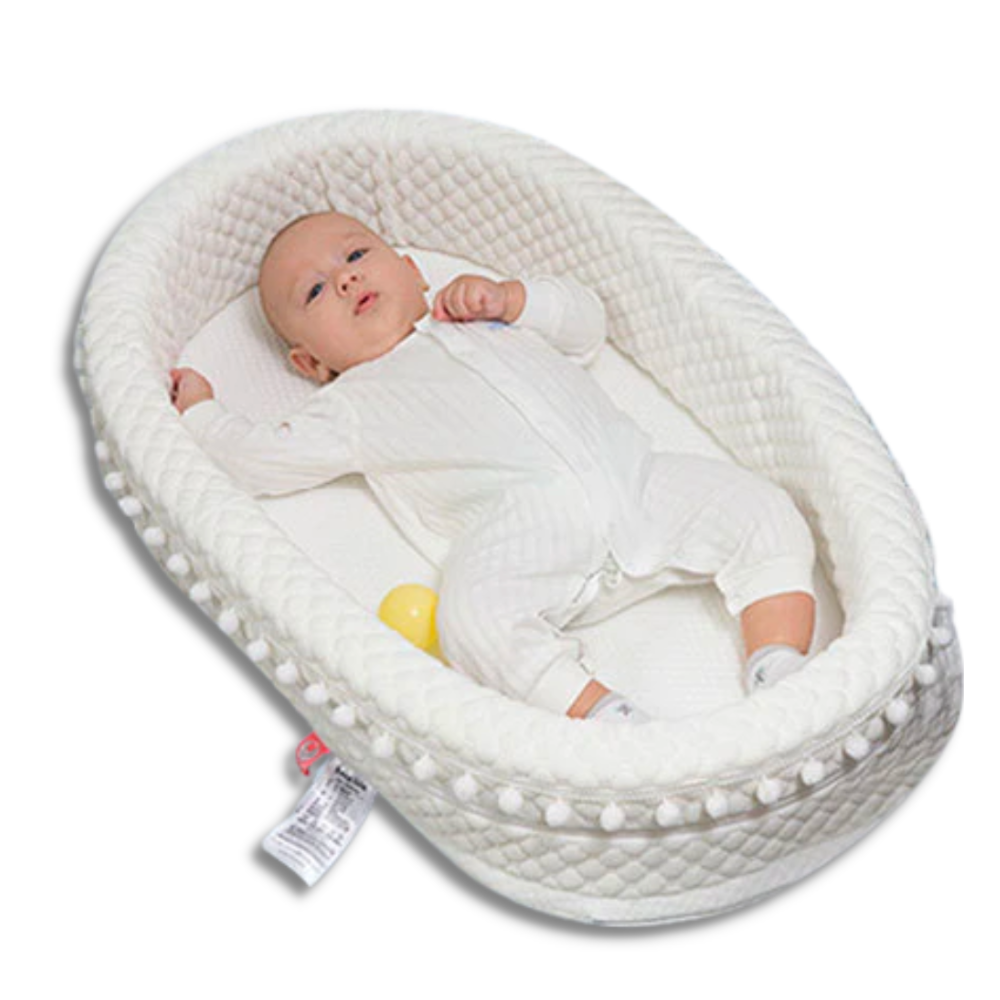 White baby nest lounger with pompoms and grey and white star blankets for reborn baby dolls.