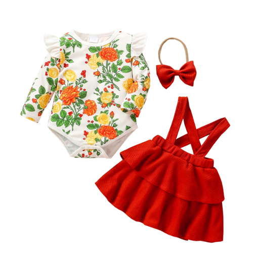 White long-sleeve onesie with white frills at the sleeve and orange and yellow floral pattern, with green leaves and red berries. Comes with a scarlet red waffle knit dress with straps that button on the inside of the dress and a matching nylon bow headband for reborn baby girls.