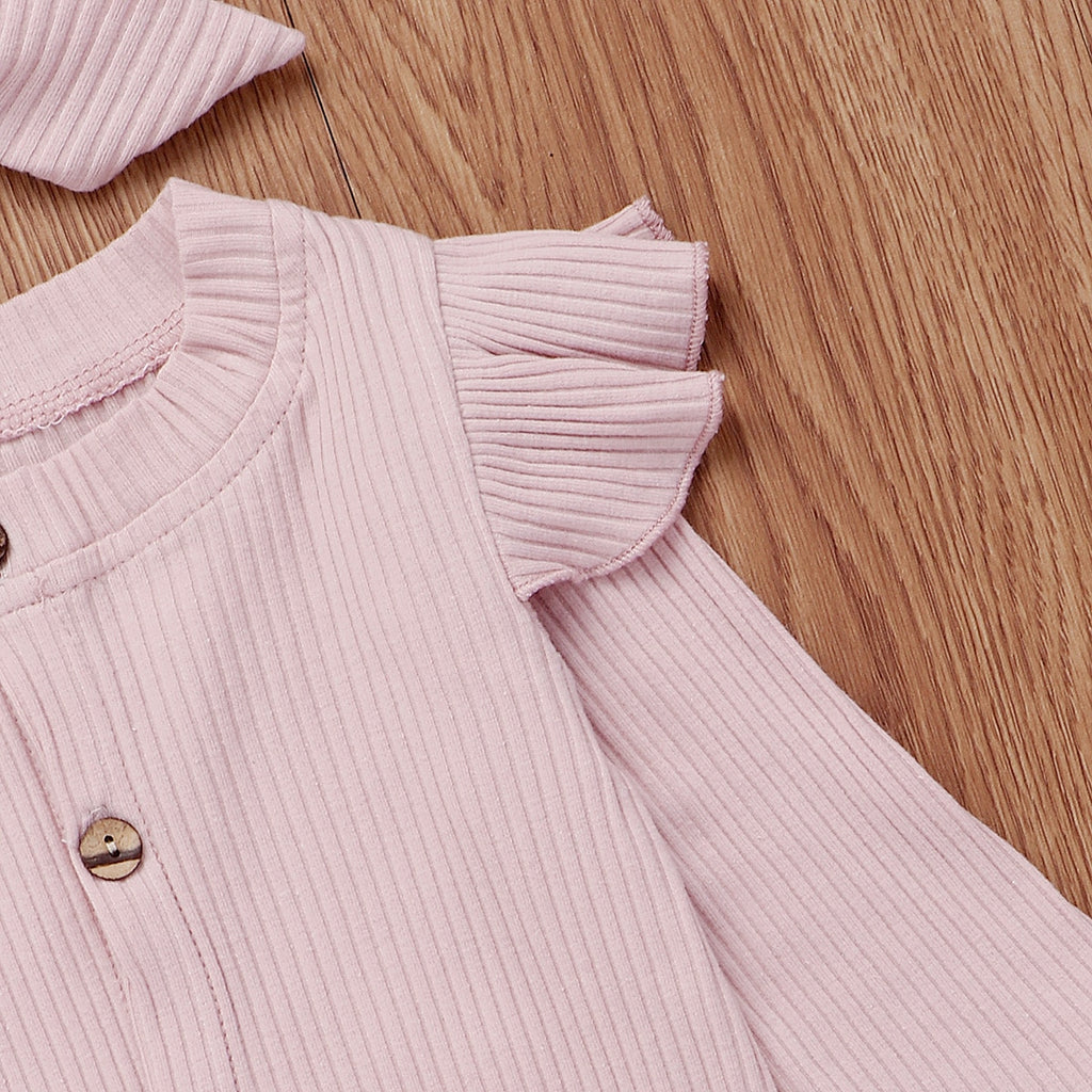 Close-up of the cap sleeve aka frilly shoulders of the baby pink boho ribbed long-sleeve jumpsuit romper with buttons, frilly shoulder sleeves and a matching headband for reborn doll clothing and baby girls.