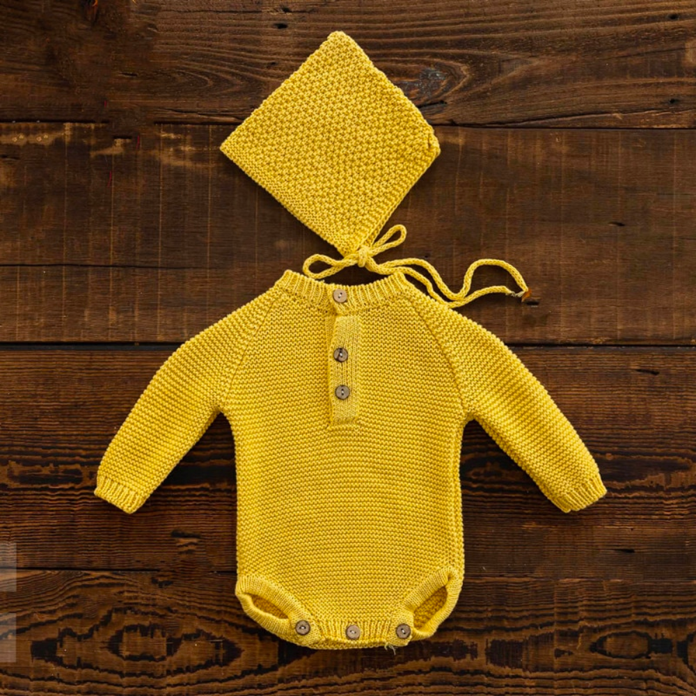 Mustard yellow long-sleeve crochet knitted baby onesie with matching pixie bonnet for reborn baby dolls and newborn photographers.