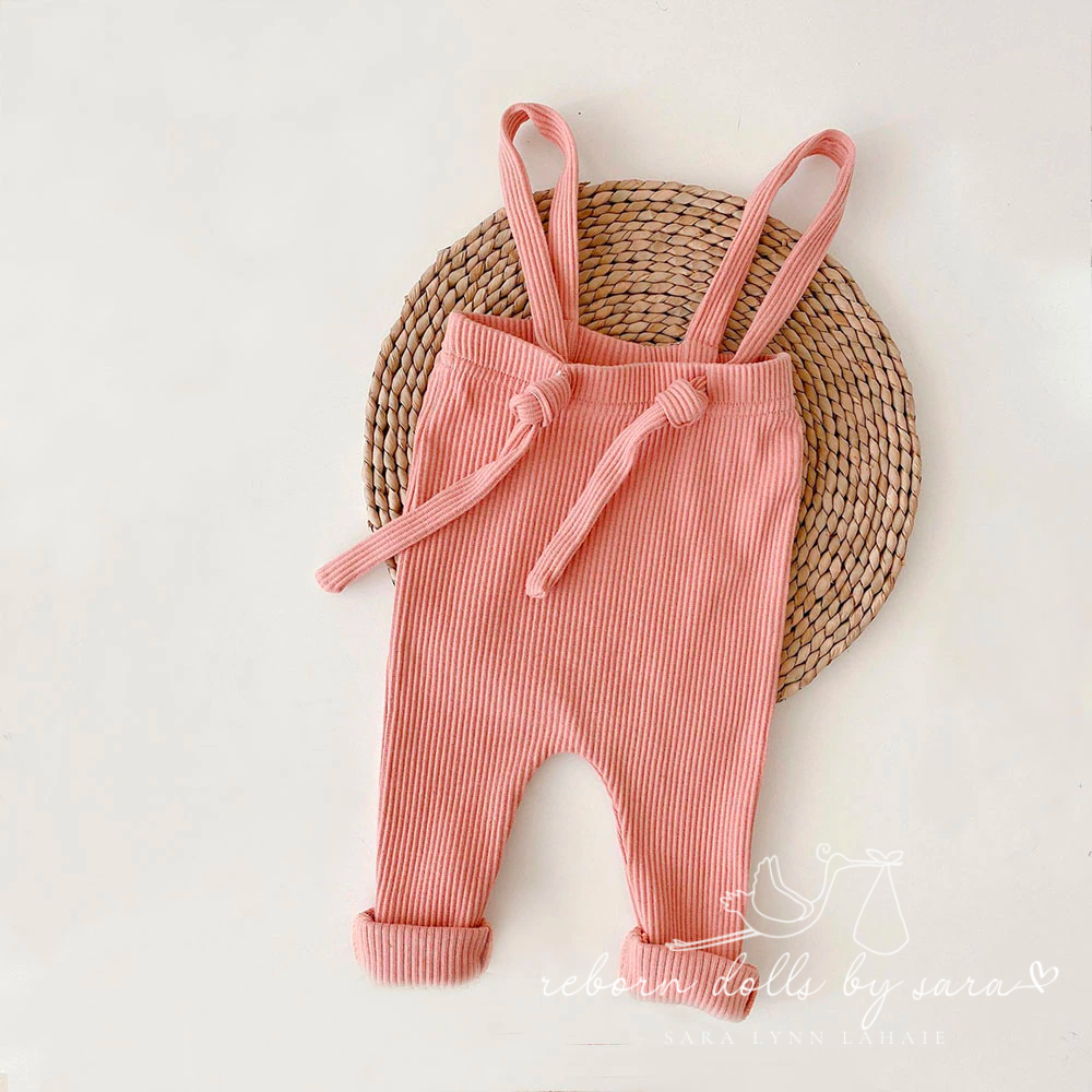 Pink colored bohemian ribbed adjustable baby overalls for reborn dolls.