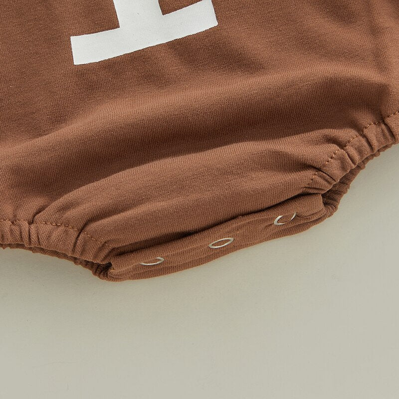 Longsleeve football baby bubble romper with a crewneck for baby boys and reborn dolls. Brown with a white stitch down the centre.