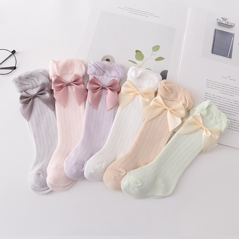 Pastel coloured Spanish baby girl socks with ruffled edge and silk bows for baby girls and reborn dolls.