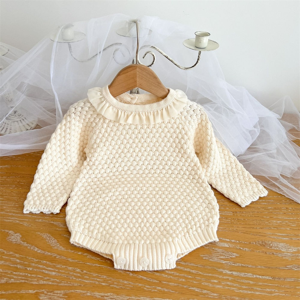 Off-white creamy white long-sleeve knitted bubble romper onesie for reborn baby girls and dolls with lace collar.