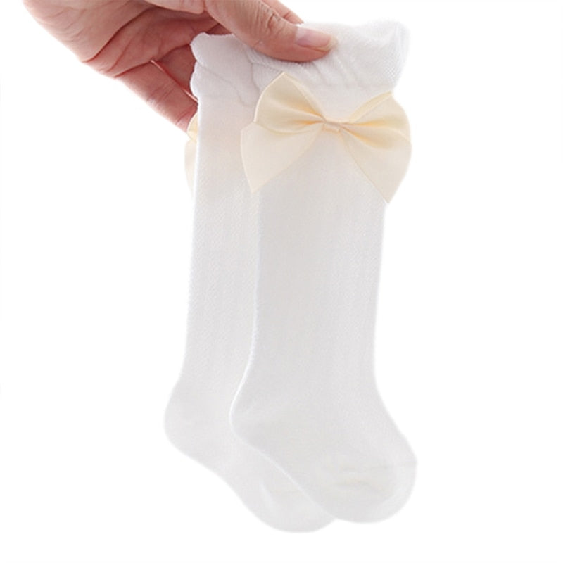 White Spanish baby girl knee-high socks with silk bows for reborn baby girls and dolls.