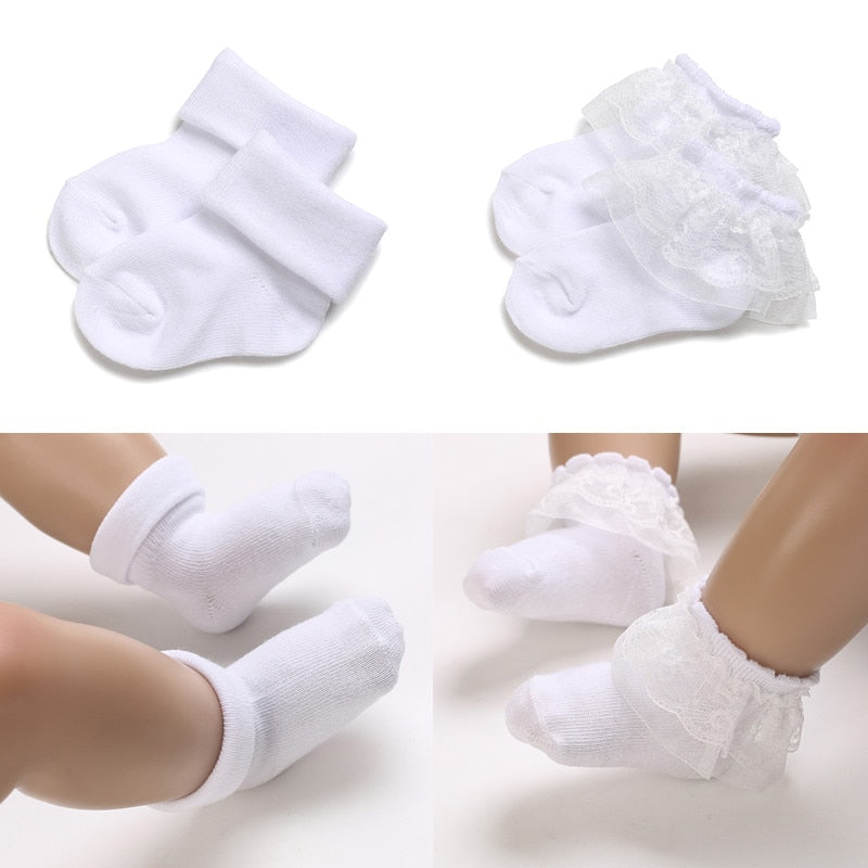 Plain white baby socks for reborn dolls and babies. One pair has lace.