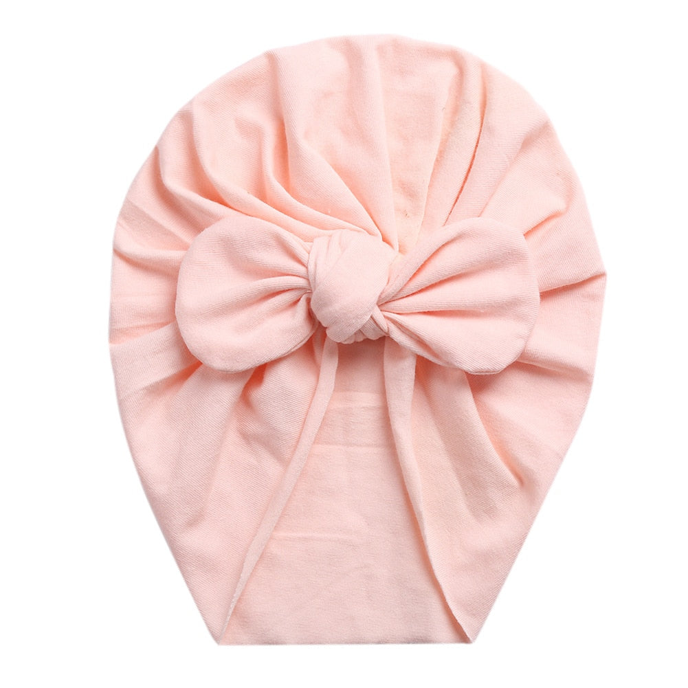 Light baby pink boho butterfly turban head wrap for newborn babies and reborn dolls.