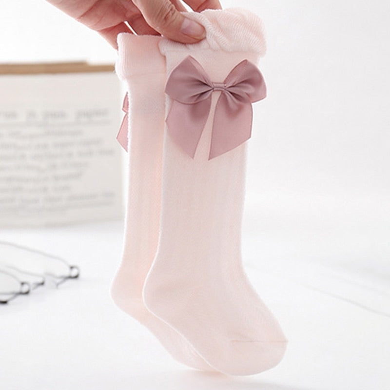 Pink Spanish baby girl knee-high socks with silk bows for reborn baby girls and dolls.