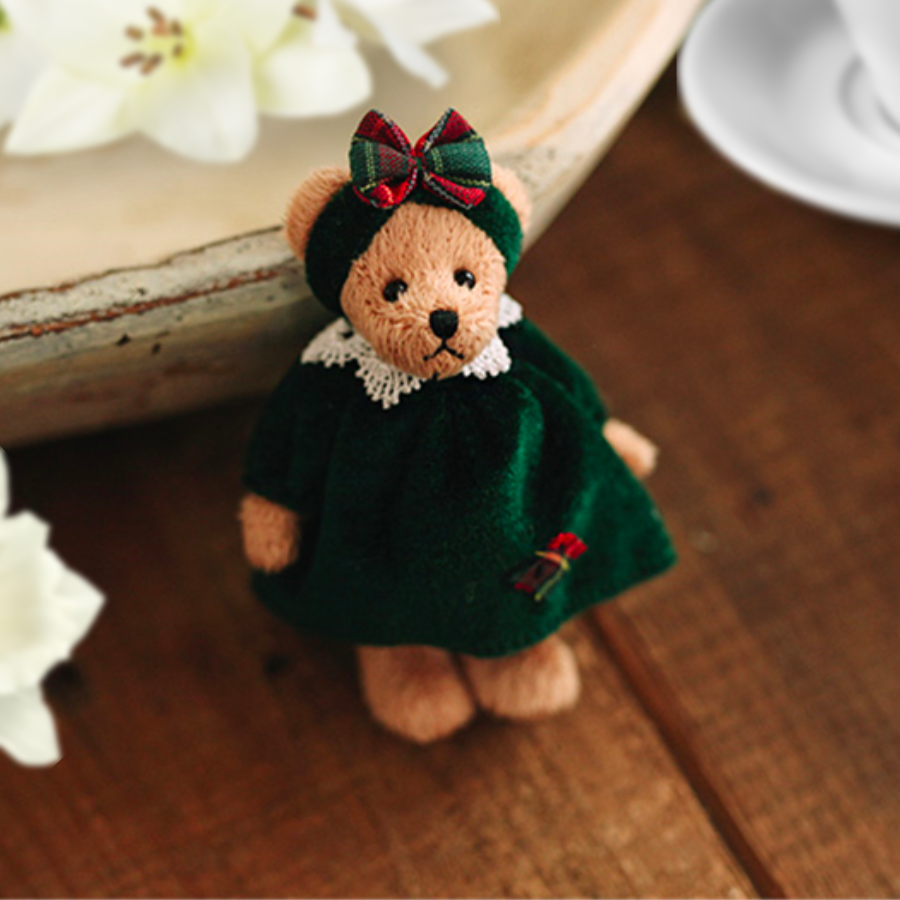 Teddy bear in a green Christmas dress. Reborn baby doll teddy bear toys that can be used by newborn photographers as well as newborn photography props.