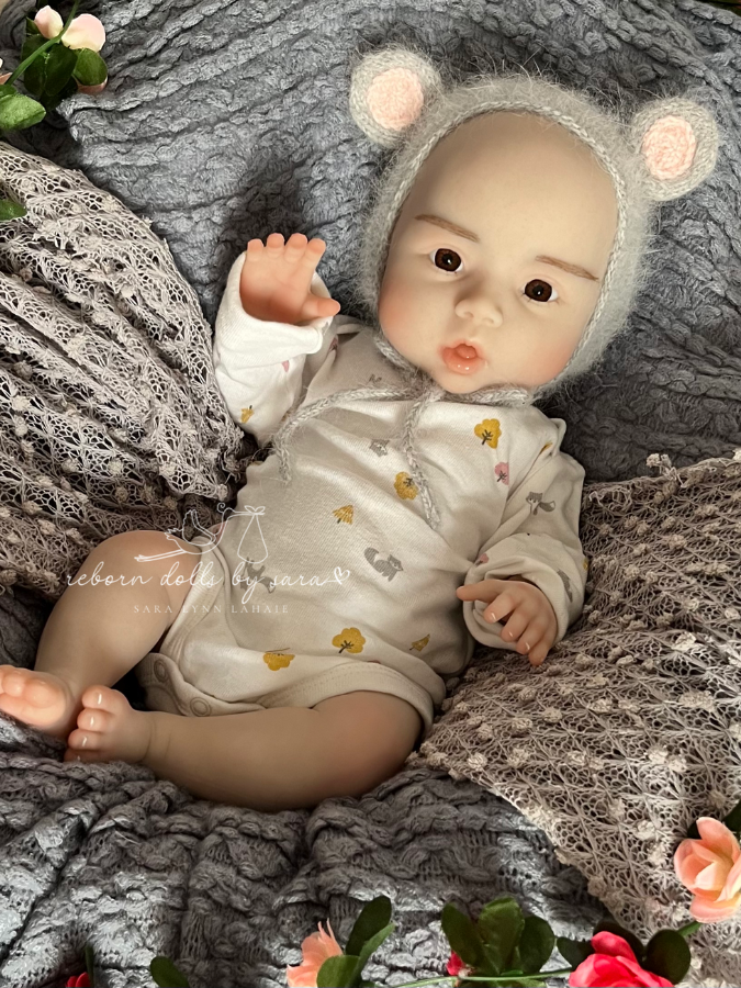 Cheap silicone reborn for sale.  Suri is a full body silicone drink and wet doll. Brown eyes, bald, floppy, squishy, and realistically weighted. Affordable. Anatomically correct baby girl.