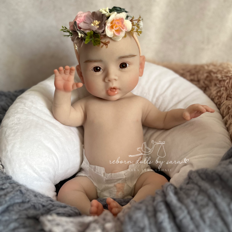 Cheap silicone reborn for sale.  Suri is a full body silicone drink and wet doll. Brown eyes, bald, floppy, squishy, and realistically weighted. Affordable. Anatomically correct baby girl.