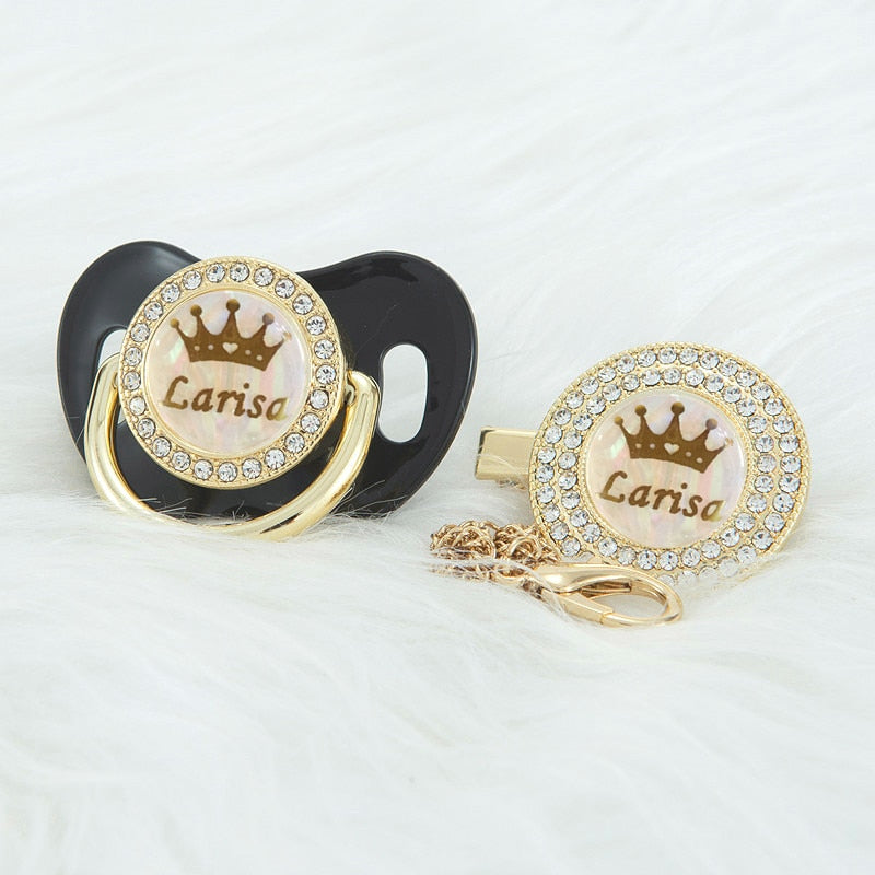 Black Prince and Princess Custom Pacifiers with baby's name and gold chain with rhinestone Pacifier Clips for reborn dolls and newborn babies.
