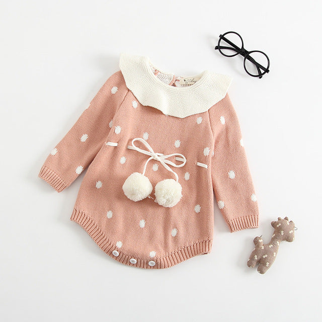 Pink white dot long sleeve knitted bubble romper with white collar and pompoms around waist.