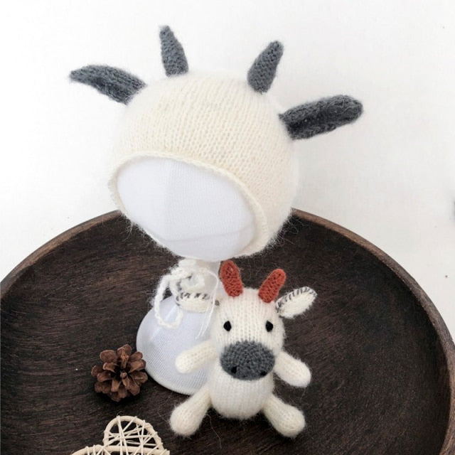 Knitted cow reborn and newborn photography hat with matching stuffie.