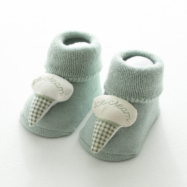 Mint green baby socks for reborns and cuddle babies with an ice cream stuffie toe accent.