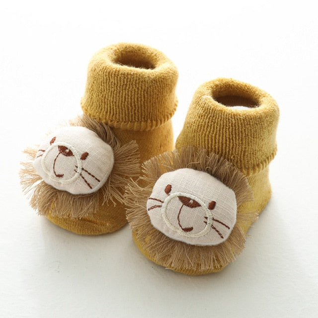 Mustard yellow baby socks for reborn dolls or cuddle babies with a stuffed lion on the toe.