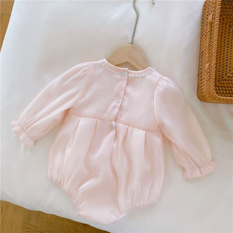 Back of Pink long-sleeve Spanish baby bubble romper onesie with lace embroidery, silk bows, and matching headbands for reborn girl dolls.