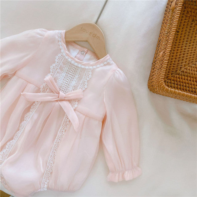 Pink long-sleeve Spanish baby bubble romper onesie with lace embroidery, silk bows, and matching headbands for reborn girl dolls.