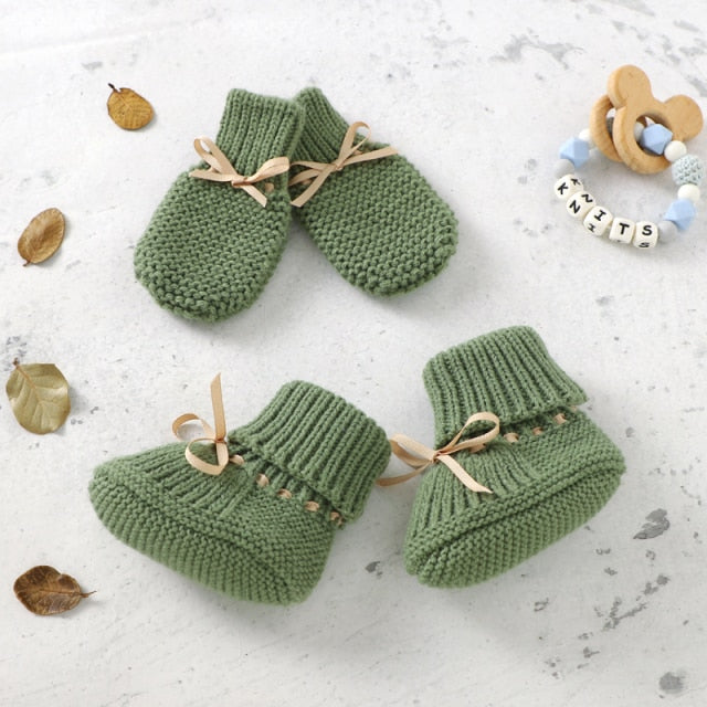Sage green crochet knit booties and anti-scratch mitts for reborn dolls with leather drawstring.