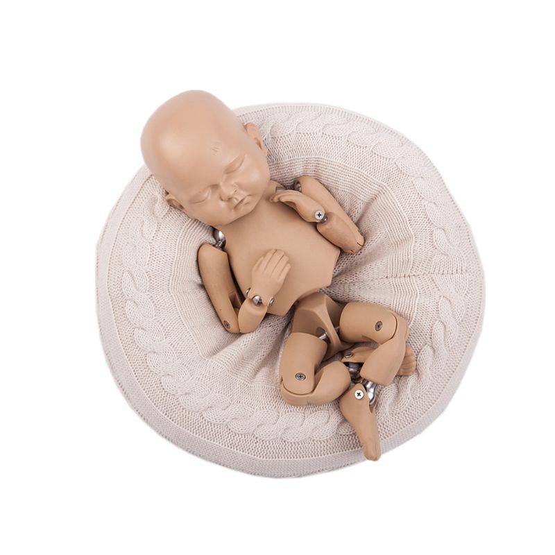 Cream/white posing pillow for reborn dolls or newborn photography with knit cover and newborn photography dummy being displayed.