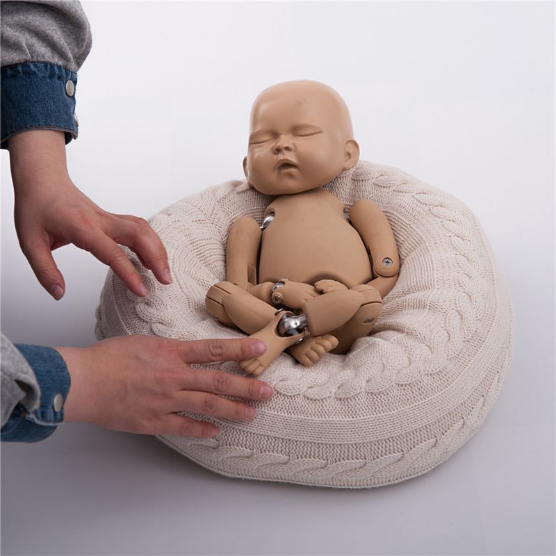 Posing the newborn photography stand-in with the cream/white posing pillow for reborn dolls or newborn photography with knit cover.